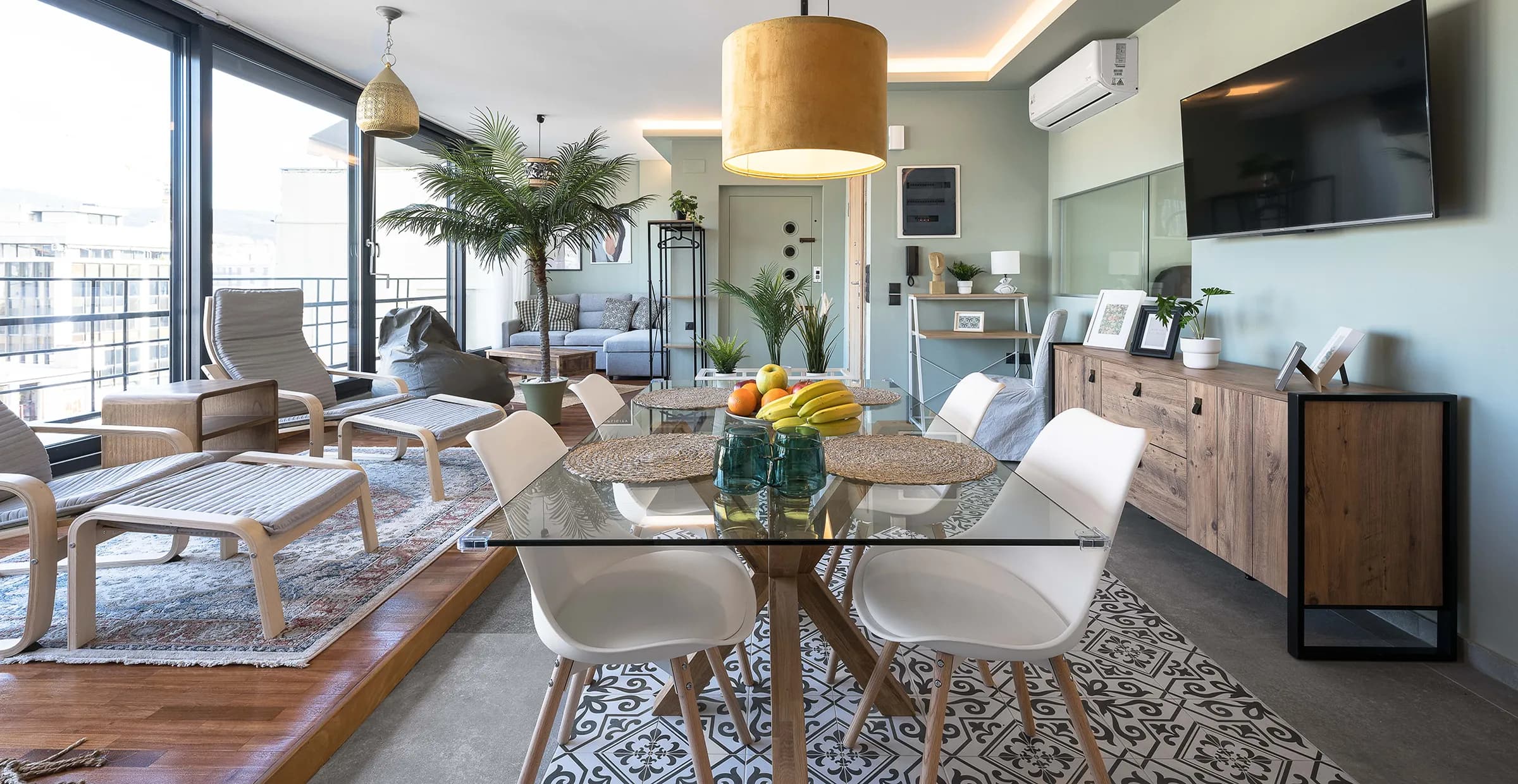 Interior view of the Okto Penthouse living room showing the dining area and hanging chair
